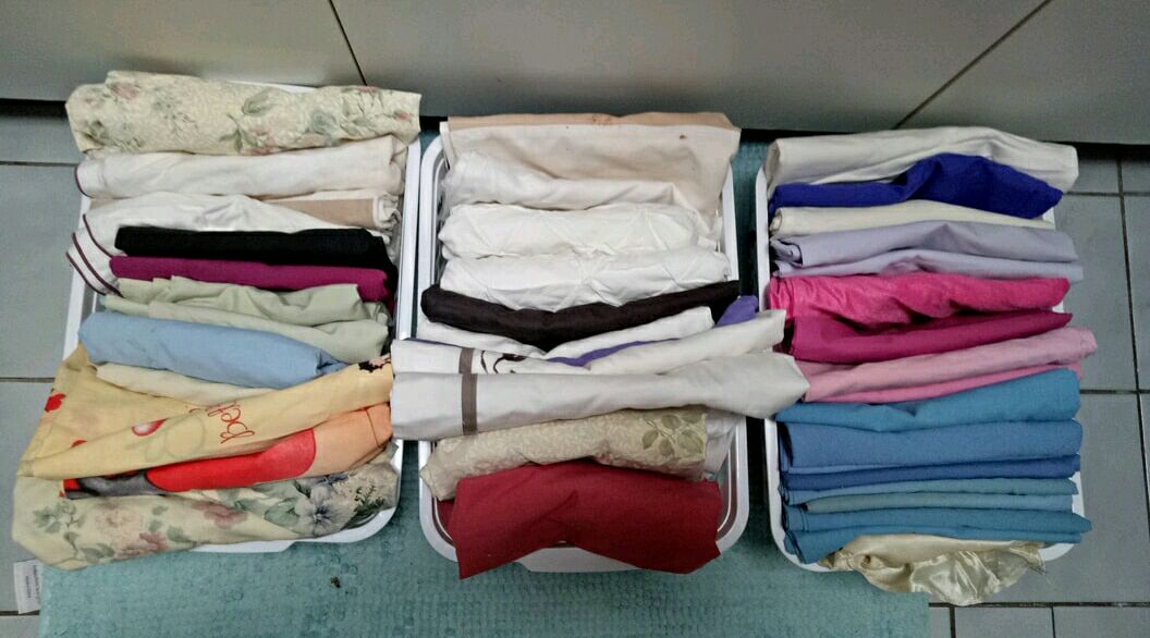 Photo of three baskets full of neatly folded pillow cases