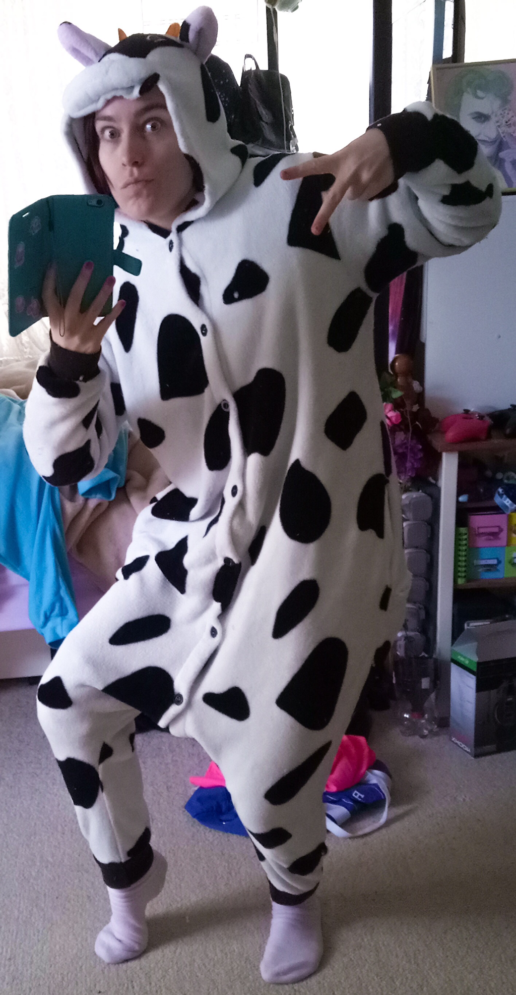 Jessica wearing the cow onesie and taking a selfie
